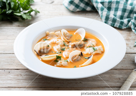 Seafood soup on wooden table Seafood soup on wooden table 107928885