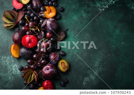 Assortment of purple fruit plum, grape, blueberry and basil Assortment of purple fruit plum, grape, blueberry and basil 107930243
