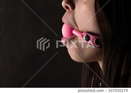 Beautiful woman in the role of a slave on black background Beautiful woman in the role of a slave on black background 107930274