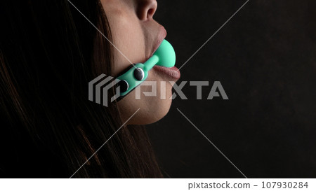Beautiful woman in the role of a slave on black background Beautiful woman in the role of a slave on black background 107930284