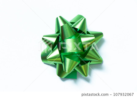 Ribbon bow banner in green color on white paper background Ribbon bow banner in green color on white paper background 107932067
