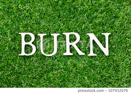 Wood letter in word burn on green grass background 107932076