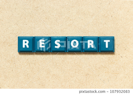 Tile alphabet letter in word resort on wood background 107932083