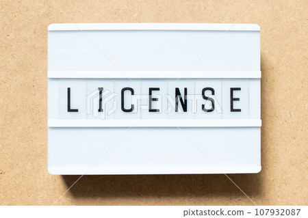 Lightbox with word license on wood background Lightbox with word license on wood background 107932087