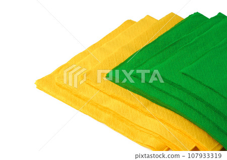 Green and yellow paper napkins on white background 107933319