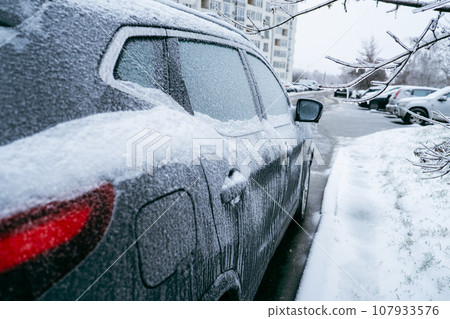 car covered with ice after snowstorm car covered with ice after snowstorm 107933576