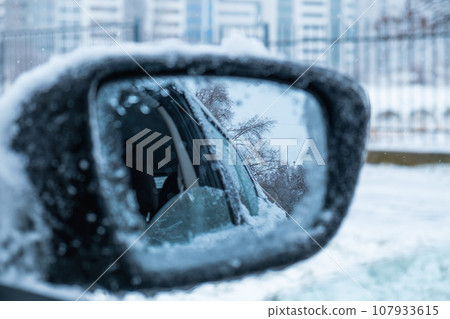 car covered with ice after snowstorm 107933615