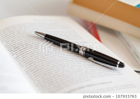 English books and pens opened on the desk Image of research and learning English books and pens opened on the desk Image of research and learning 107933763