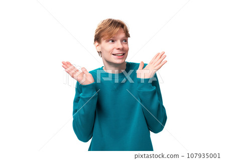 young cheerful handsome man with red hair dressed in a blue jacket on a white background with copy young cheerful handsome man with red hair dressed in a blue jacket on a white background with copy 107935001