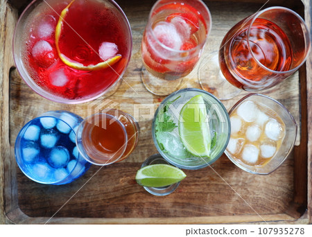 Set of wine, brandy, liqueur, grappe, cocktail, mojito, cognac, whiskey in glasses. Large variety of alcohol and spirits for making cocktails and drink Set of wine, brandy, liqueur, grappe, cocktail, mojito, cognac, whiskey in glasses. Large variety of alcohol and spirits for making cocktails and drink 107935278