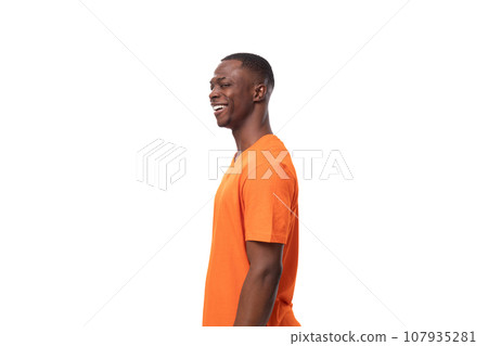 young successful handsome african man dressed in orange t-shirt on studio white background 107935281