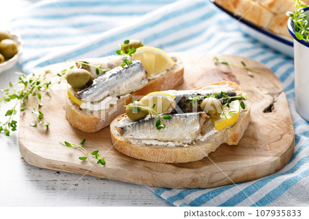 Sardines sandwiches on a white wooden background. Mediterranean food 107935833