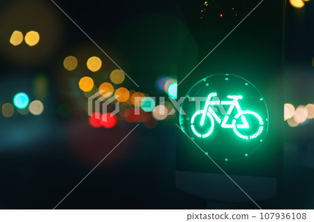 Bicycle green allowing lamp sign on traffic light road highway driveway drive crossroad intersection evening dark time german city. Bike forward movement safe on semaphore signal city street 107936108