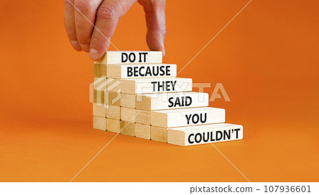 You can do it symbol. Concept words Do it because they said you could not on wooden block. Beautiful orange table background. Businessman hand. Business, motivational you can do it concept. Copy space 107936601
