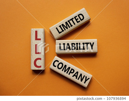 LLC - Limited liability company. Wooden cubes with word LLC. Beautiful orange background. Business and LLC concept. Copy space. LLC - Limited liability company. Wooden cubes with word LLC. Beautiful orange background. Business and LLC concept. Copy space. 107936894