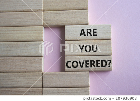 Are you covered symbol. Concept words Are you covered on wooden blocks. Beautiful pink background. Business and Are you covered concept. Copy space. 107936908