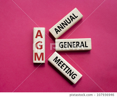 AGM - Annual general meeting symbol. Concept word AGM on wooden cubes. Beautiful red background. Business and AGM concept. Copy space. AGM - Annual general meeting symbol. Concept word AGM on wooden cubes. Beautiful red background. Business and AGM concept. Copy space. 107936946