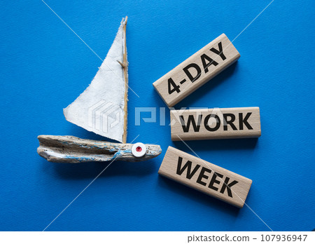 4-day work week symbol. Concept words 4-day work week on wooden blocks. Beautiful blue background with boat. Business and 4-day work week concept. Copy space 4-day work week symbol. Concept words 4-day work week on wooden blocks. Beautiful blue background with boat. Business and 4-day work week concept. Copy space 107936947