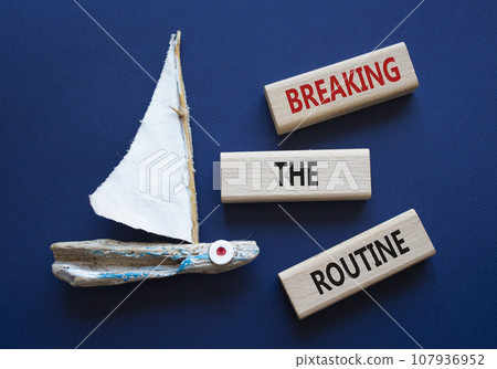 Breaking the Routine week symbol. Concept words Breaking the Routine on wooden blocks. Beautiful deep blue background with boat. Business and Breaking the Routine concept. Copy space 107936952