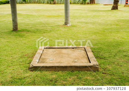 Pond in the garden drainage system with green grass. 107937128