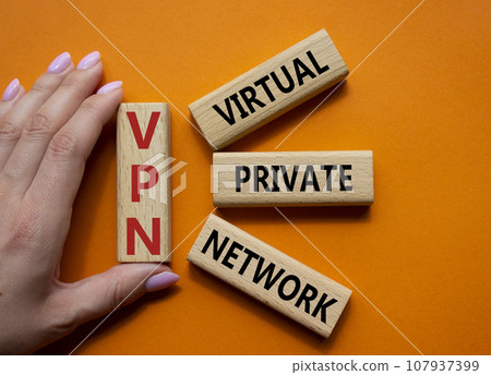 VPN - Virtual Private Network. Wooden cubes with word VPN. Businessman hand. Beautiful orange background. Business and VPN concept. Copy space. VPN - Virtual Private Network. Wooden cubes with word VPN. Businessman hand. Beautiful orange background. Business and VPN concept. Copy space. 107937399