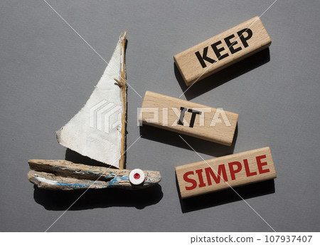 Keep it Simple symbol. Concept words Keep it Simple on wooden blocks. Beautiful grey background with boat. Business and Keep it Simple concept. Copy space. 107937407