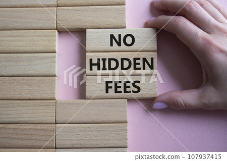 No Hidden Fees symbol. Concept words No Hidden Fees on wooden blocks. Businessman hand. Beautiful pink background. Business and No Hidden Fees concept. Copy space. 107937415