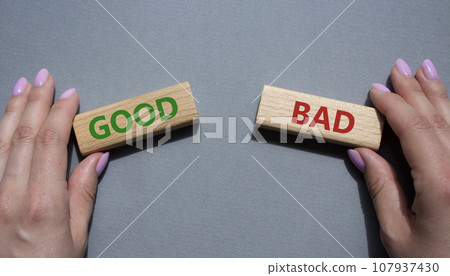 Good or Bad symbol. Concept word Good or Bad on wooden blocks. Businessman hand. Beautiful grey background. Business and Good or Bad concept. Copy space 107937430