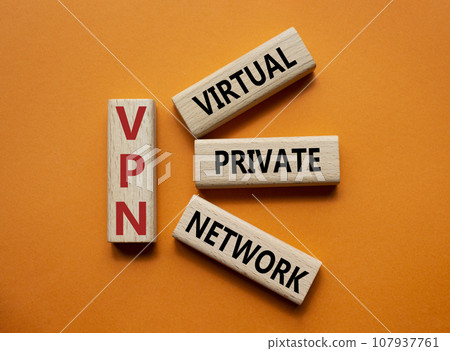 VPN - Virtual Private Network. Wooden cubes with word VPN. Beautiful orange background. Business and VPN concept. Copy space. 107937761