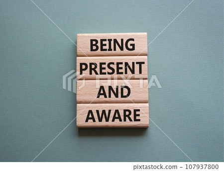 Being Present and Aware symbol. Wooden blocks with words Being Present and Aware. Doctor hand. Beautiful grey green background. Psychology and Being Present and Aware concept. Copy space. Being Present and Aware symbol. Wooden blocks with words Being Present and Aware. Doctor hand. Beautiful grey green background. Psychology and Being Present and Aware concept. Copy space. 107937800