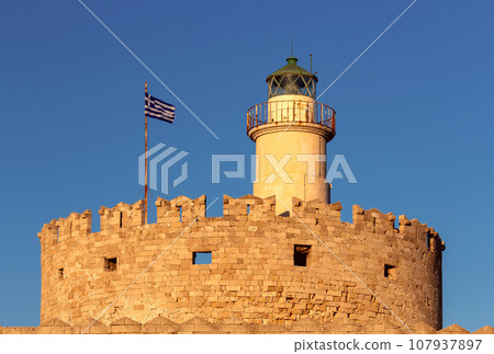 Old stone lighthouse on the breakwater in Rhodes. Old stone lighthouse on the breakwater in Rhodes. 107937897