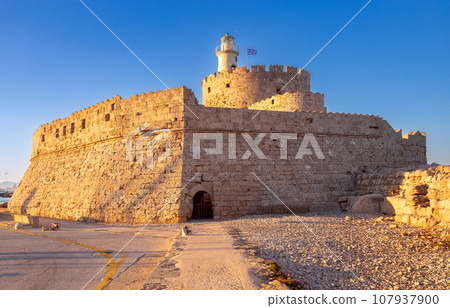 Old stone lighthouse on the breakwater in Rhodes. 107937900