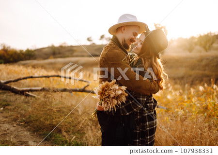 Lovely hipster couple enjoying each other in the autumn park. Nice autumn day. love and lifestyle. 107938331