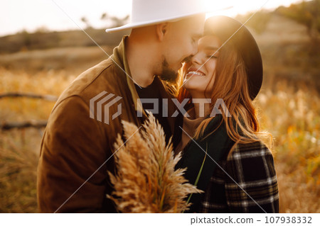 Lovely hipster couple resting in nature. People, lifestyle, relaxation and vacations concept. 107938332