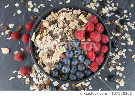 Muesli with raspberries and blueberries Muesli with raspberries and blueberries 107938368