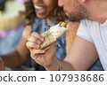 man is holding a vegan burrito in his hand 107938686