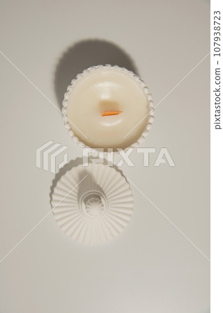 Handmade ceramic decorative white candles on the white background Handmade ceramic decorative white candles on the white background 107938723