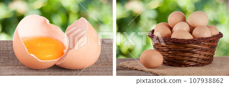 Broken egg with yolk and eggshell On a wooden table with a blurry garden background Broken egg with yolk and eggshell On a wooden table with a blurry garden background 107938862