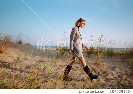 Fashion Model posing near the sea. Young woman resting in nature. People, lifestyle, relaxation. 107939100