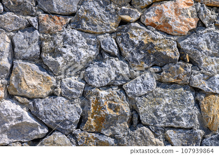 fence made of beautiful gray wild stone as a background 5 107939864