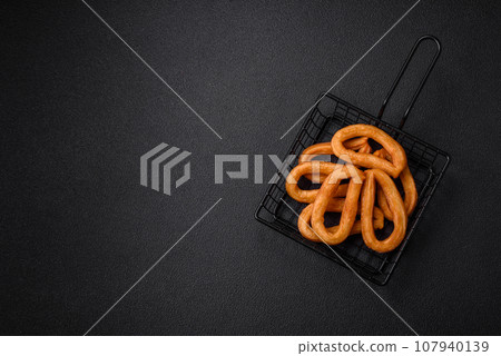 Delicious sweet churos with powdered sugar and cream inside 107940139