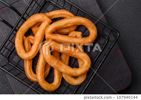 Delicious sweet churos with powdered sugar and cream inside Delicious sweet churos with powdered sugar and cream inside 107940144