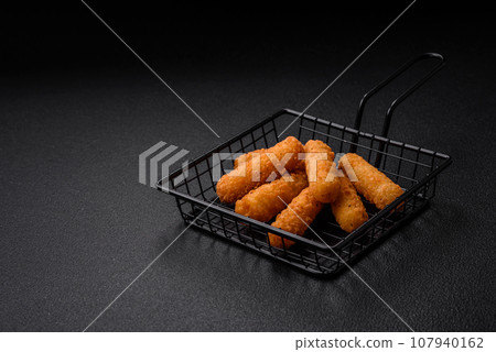 Delicious crispy cheese sticks with mozzarella, salt and spices, breaded Delicious crispy cheese sticks with mozzarella, salt and spices, breaded 107940162