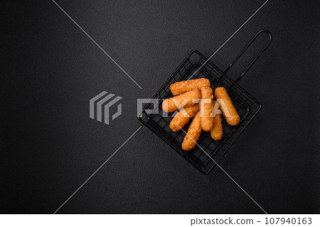 Delicious crispy cheese sticks with mozzarella, salt and spices, breaded 107940163