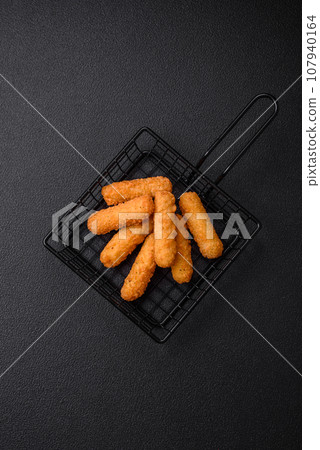 Delicious crispy cheese sticks with mozzarella, salt and spices, breaded 107940164