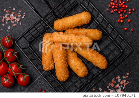 Delicious crispy cheese sticks with mozzarella, salt and spices, breaded 107940171