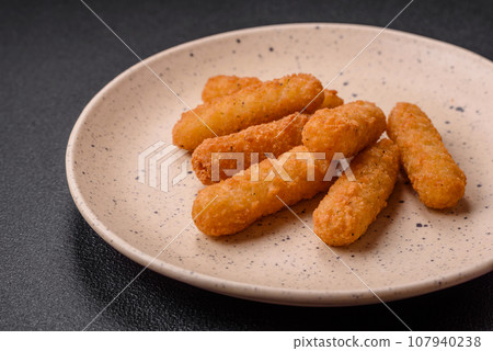 Delicious crispy cheese sticks with mozzarella, salt and spices 107940238