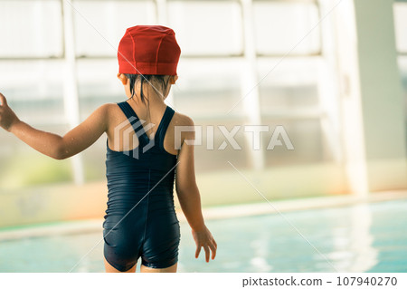 Rear view of a 4 year old child at swimming school Rear view of a 4 year old child at swimming school 107940270