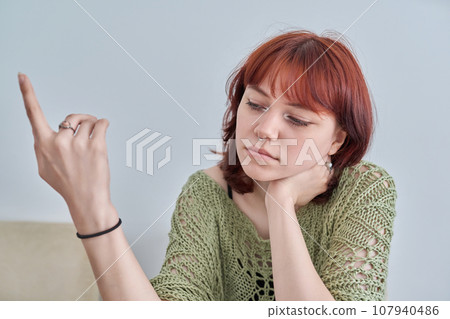 Sad upset teenage female, red-haired girl 19, 20 years old face close-up Sad upset teenage female, red-haired girl 19, 20 years old face close-up 107940486