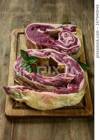 Beef ribs ready for roasting, prepared on the wooden table, traditional Argentine food. 107940648